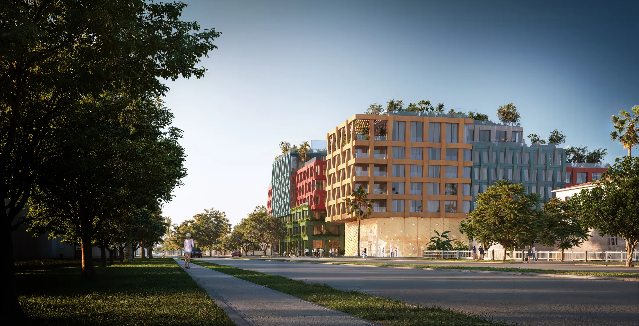 WOMA's textile façade seen from NW 5th Avenue, retail glowing at street level